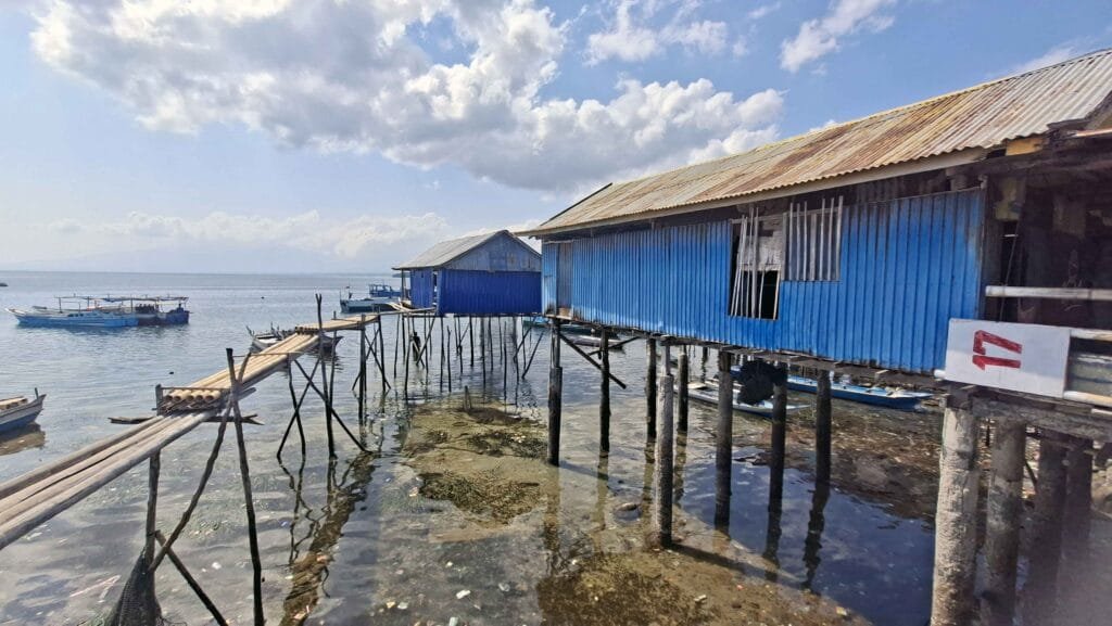 Traditional stilt houses built above the sea in Wuring Fishing Village, Flores